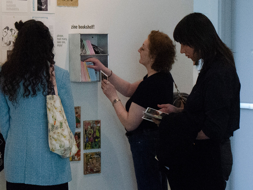 group of people reading zines at my senior exhibit